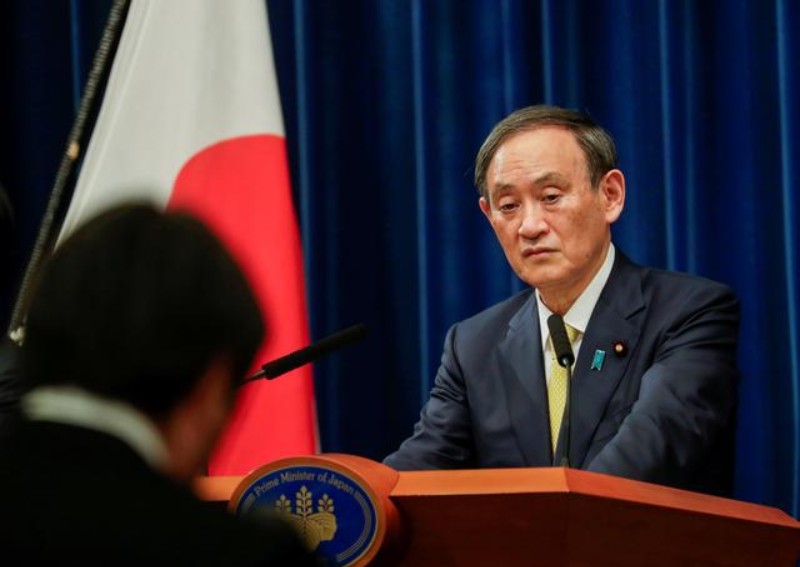 Japan PM Suga apologises after lawmakers' night club outings
