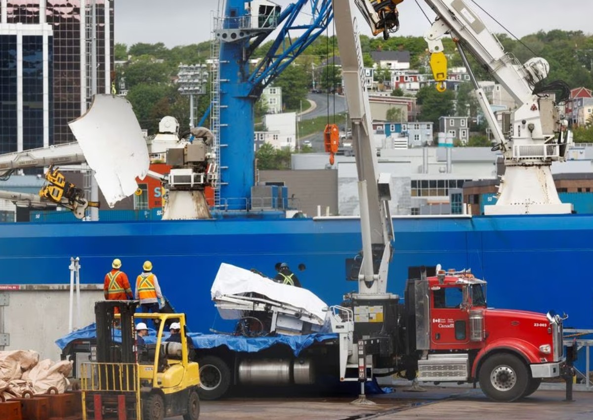 Presumed human remains and shattered Titanic submersible returned to shore