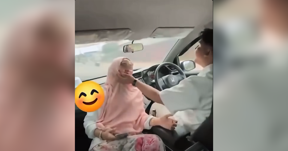 Man in Malaysia seen driving with unbelted woman sitting facing him; authorities investigating
