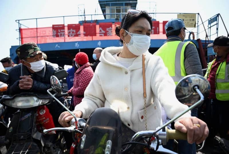 China reports 20 new virus cases, but jump in 'imported' infections