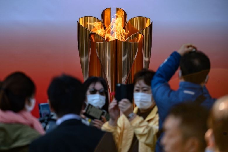 Thousands flock to see Olympic flame in Japan despite coronavirus fears