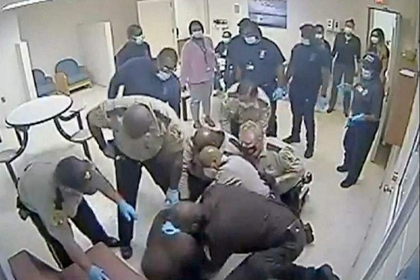 Video shows US sheriff deputies restraining black man before he died at mental hospital