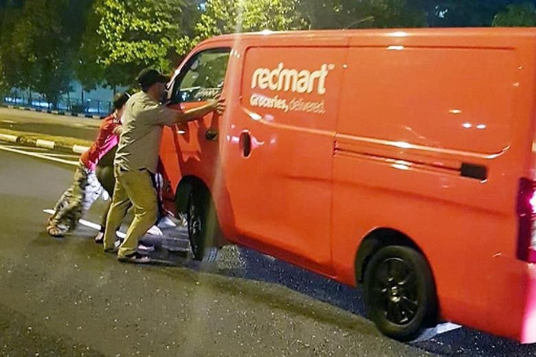 Passers-by lift van to free trapped woman after crash