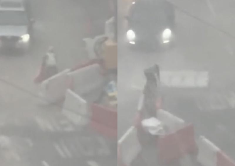 'Be patient, drivers': Construction worker at Novena seen picking up floating barrier during downpour 