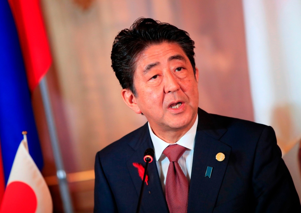 Japan PM Abe pledges to go ahead with sales tax hike next year