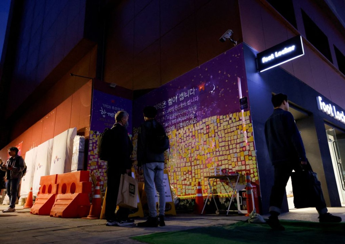 Posters, flowers commemorating the dead instead of seasonal decorations: Itaewon mourns dead a year after Halloween crush