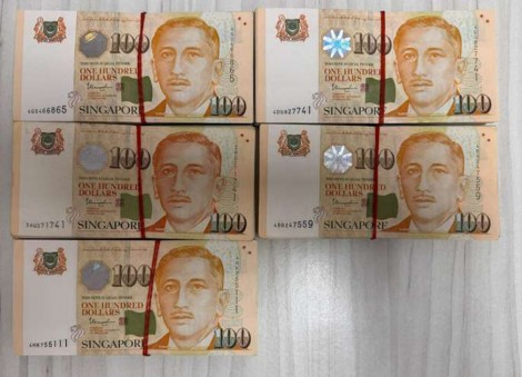 Malaysian woman to be charged over alleged scam after man seen handing her $50k in cash