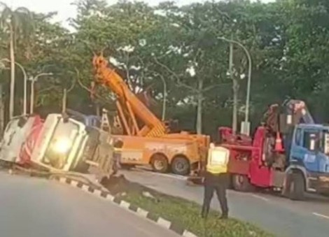 Tipper truck skids into drain on ECP slip road, driver taken to hospital