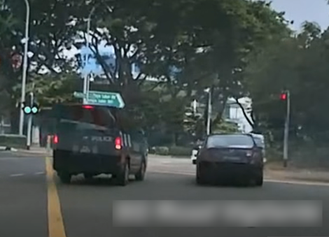 Car squeezes past police van during right turn to get ahead but gets pulled over 