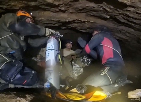 Rescuers pull 4 from flooded cave in Laos, 2 still missing