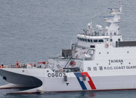 China's coast guard monitors the Philippines resupplying vessel at disputed shoal