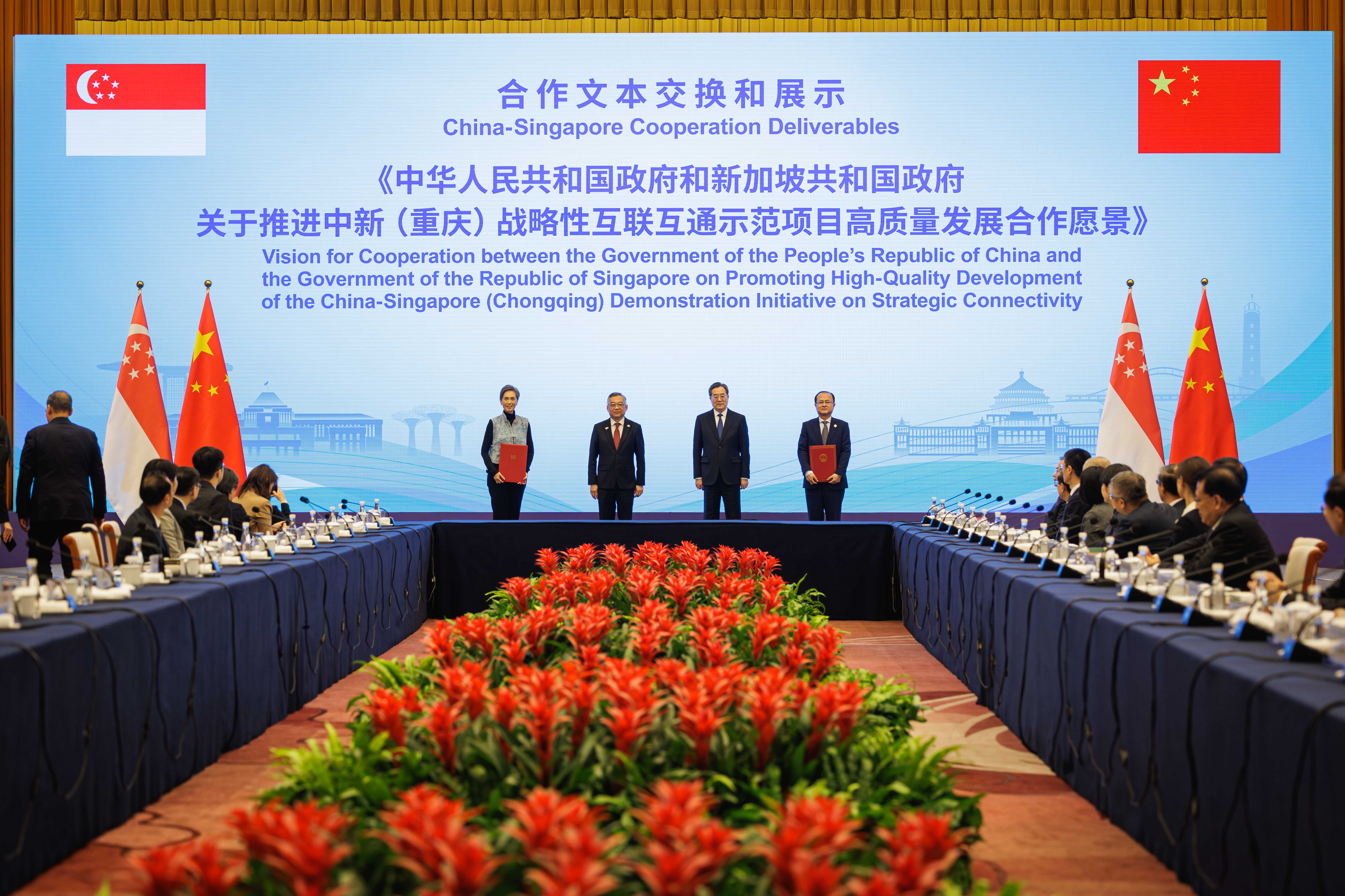 Singapore's Deputy Prime Minister Gan Kim Yong and Chinese Vice Premier Ding Xuexiang witnessing the exchange of a document setting out the long-term aspirations for the Chongqing Connectivity Initiative's next decade.