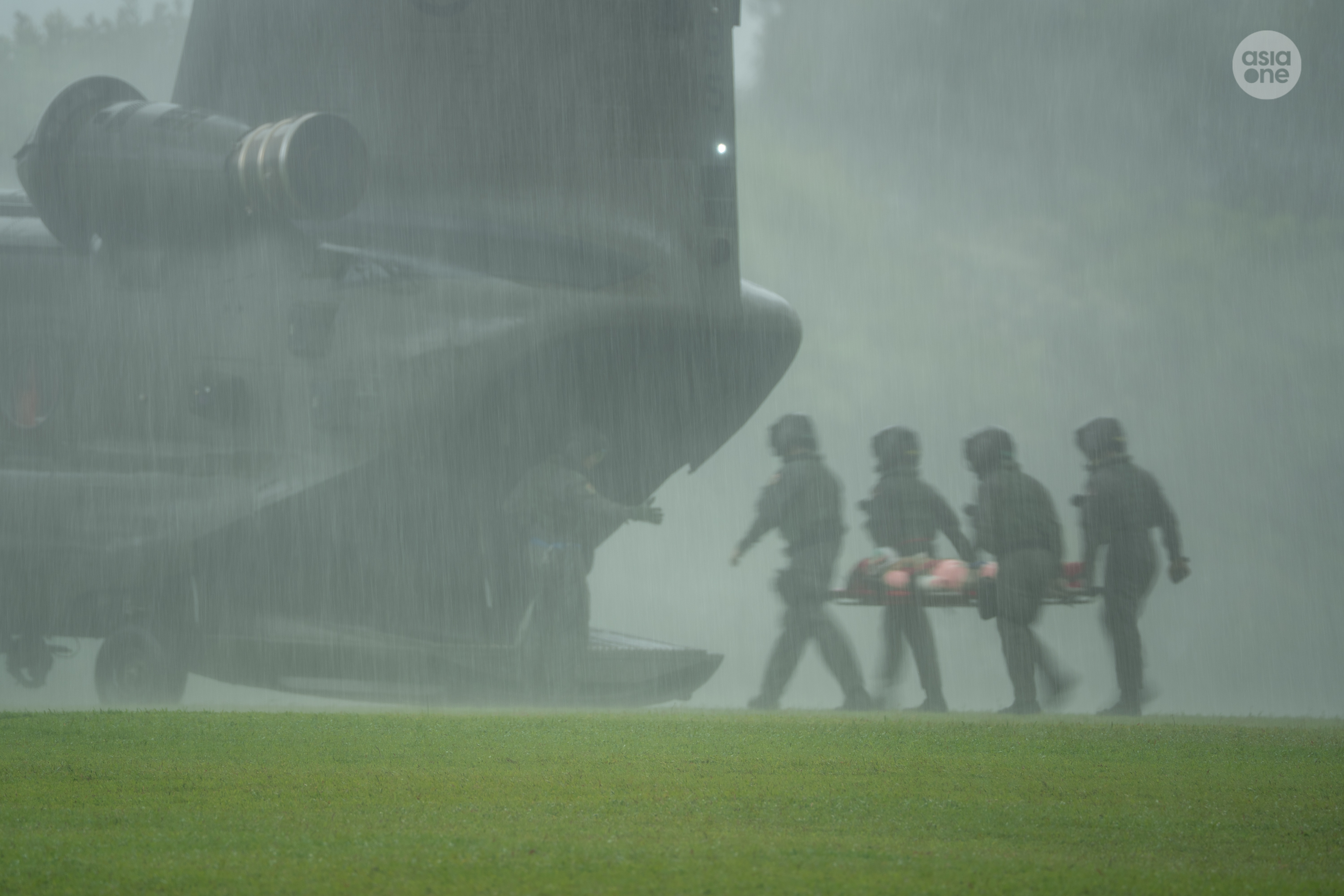 RSAF personnel returning to the Chinook helicopter after completing the medical evacuation exercise.